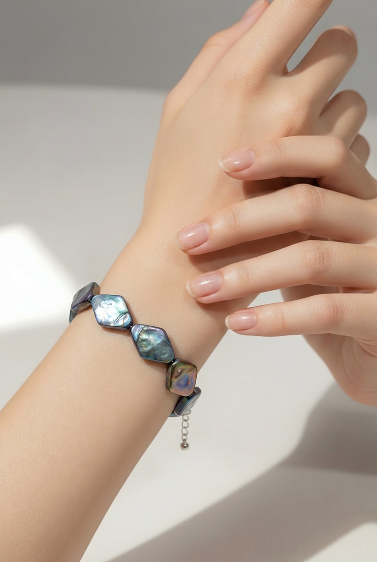 Apex dark blue pearl bracelet — worn on wrist